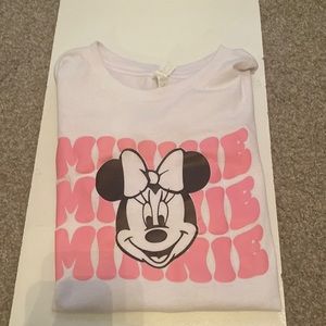 A white short sleeve T-shirt with Minnie Mouse on it and pink writing.